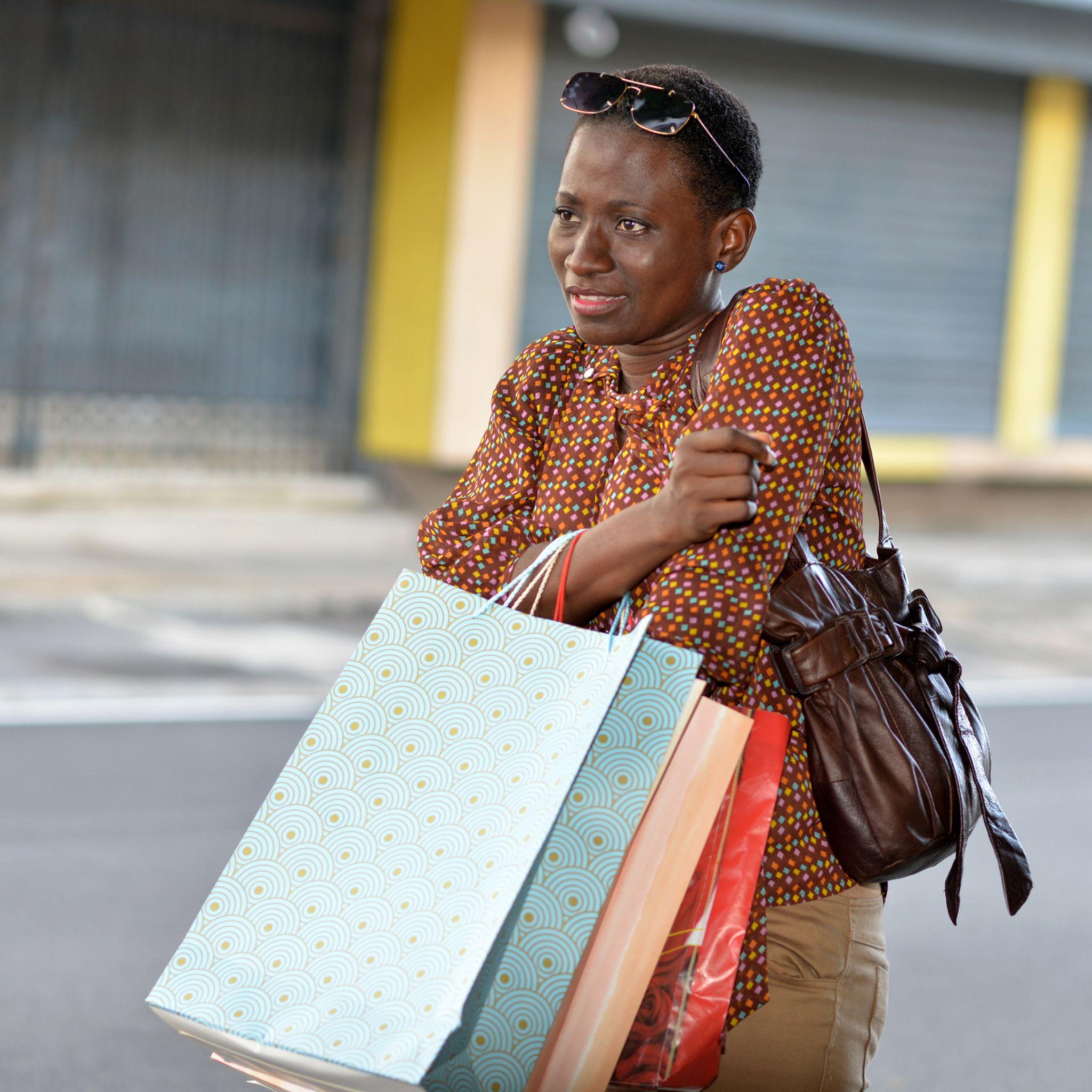 Lady with plenty shopping bags devastated by the amount of money she spent from buying things on impulse