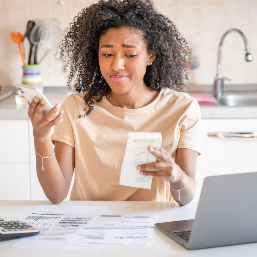 Lady working on her expenses and readjusting personal budget